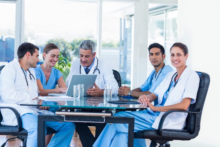 Team of smiling doctors having a meeting in the meeting room